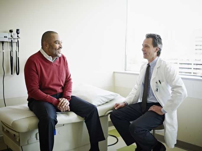 Mature male patient in discussion with doctor